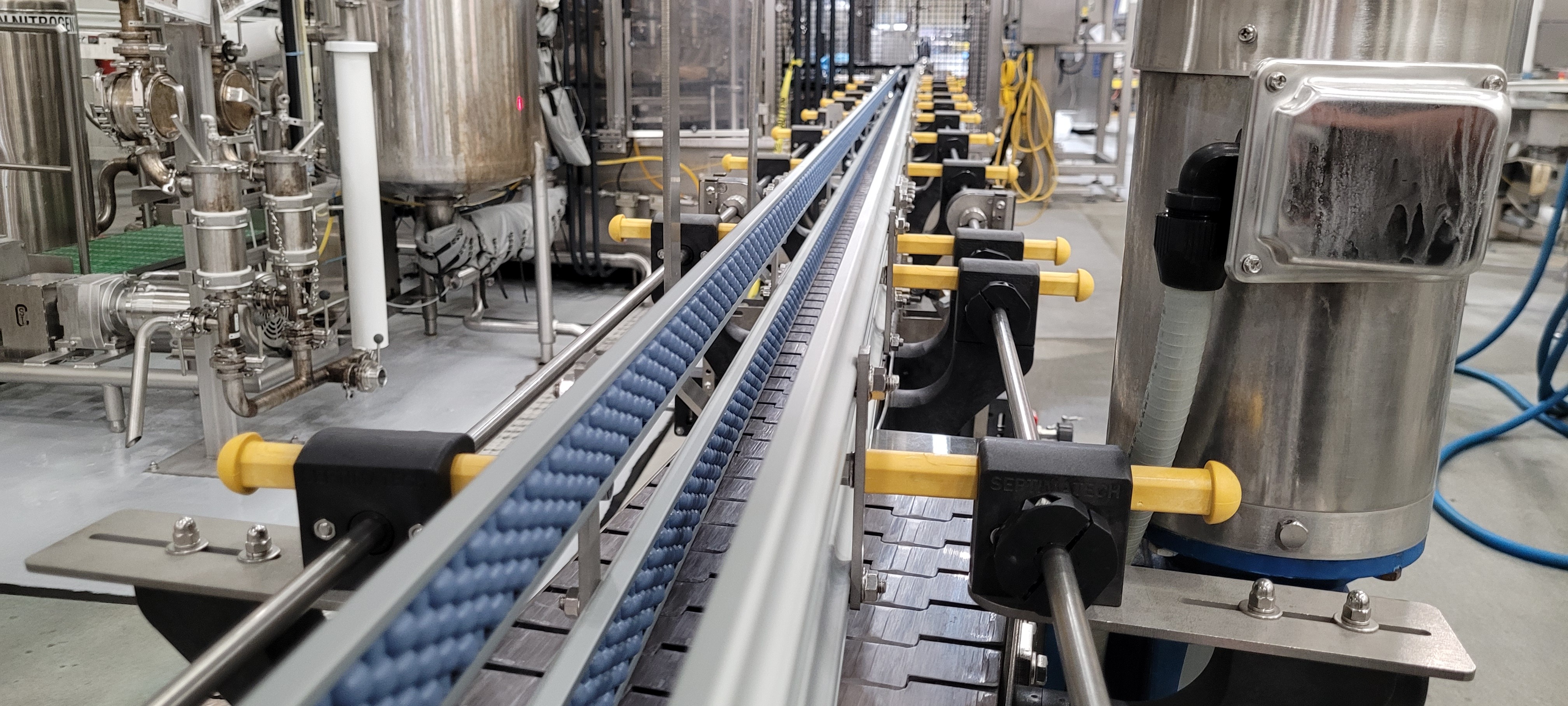 Septimatech's adjustable guide rail system with added beaded guiderails on a straight section of conveyor.