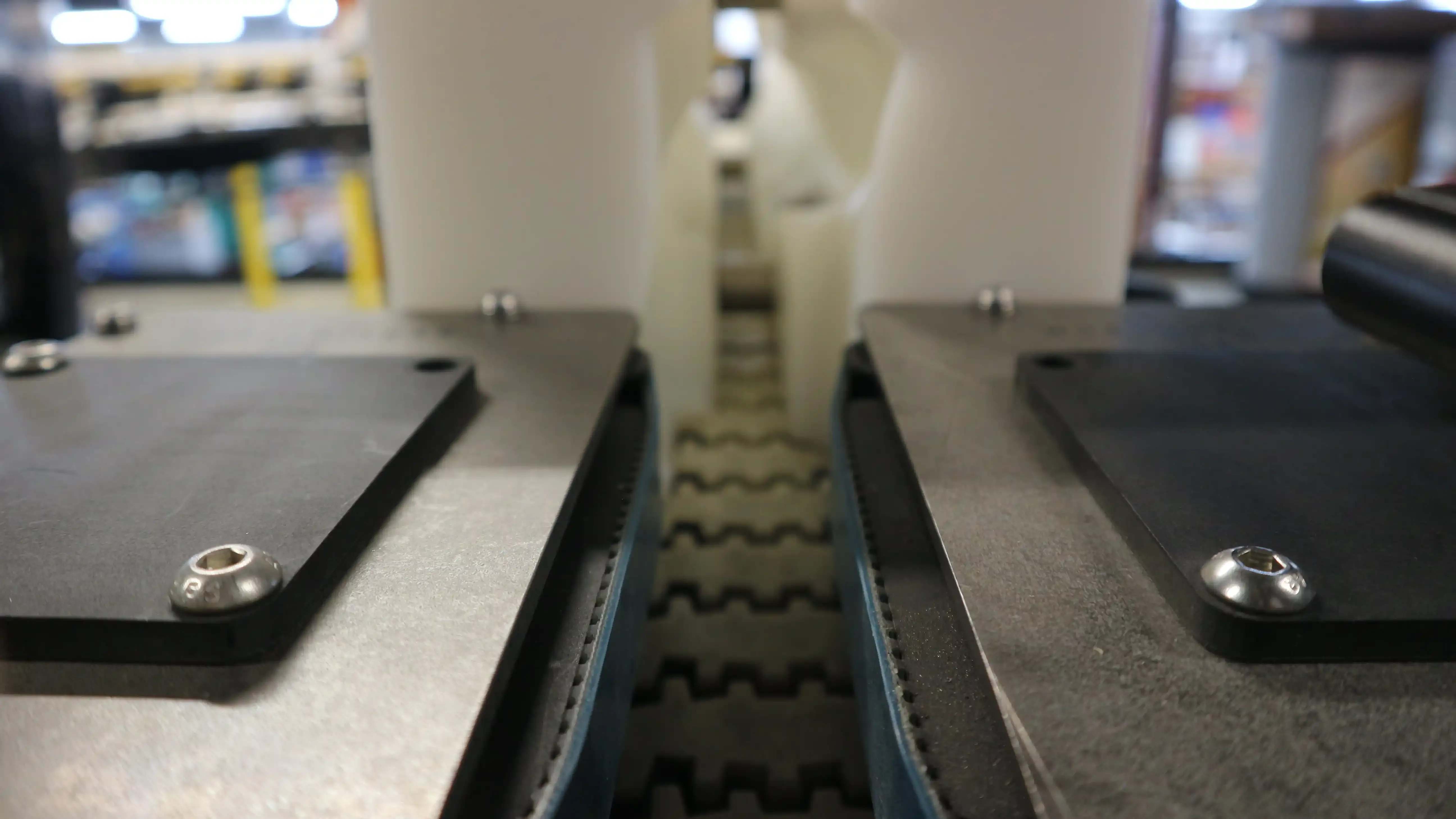 Septimatech's Horizontal Belt drive unit on a conveyor with the 270° bottle inverter unit's infeed section in the back ground.